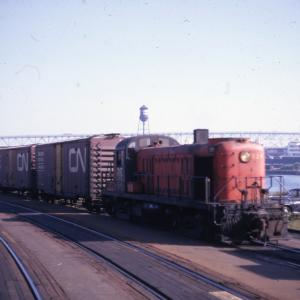 3/4 front end view of the engineer's side of RS-3 #529 on the New Haven-Central Vermont interchange track at New London - Gold Star Memorial Bridge in distant background.