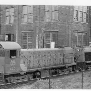 Lima-Hamilton 1200 HP DEY-6 yard switcher #630 and #639 parked adjacent to Midland Route track embankment at northeastern corner of loco erecting shop building.