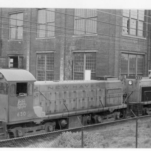 Lima-Hamilton 1200 HP DEY-6 yard switcher #630 and #639 parked adjacent to Midland Route track embankment at northeastern corner of loco erecting shop building.